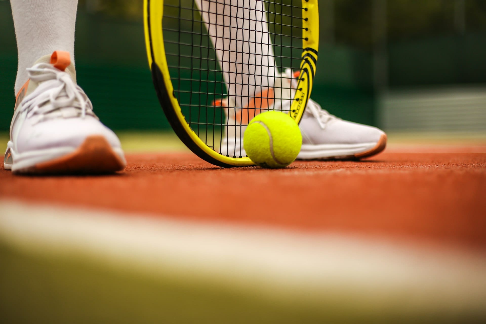 Junior tennis player serving